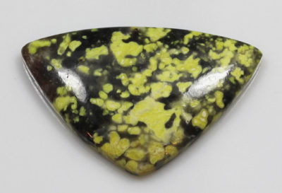 A yellow and black jasper triangle shaped pendant.