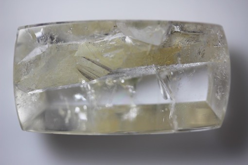 A piece of Quartz with Negative Crystal 54.45cts Cabochon Cushion Cut 32.68 x 16.82mm Brazil H7 g1006 on a white surface.