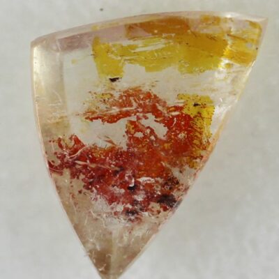 A triangular piece of yellow and orange quartz.