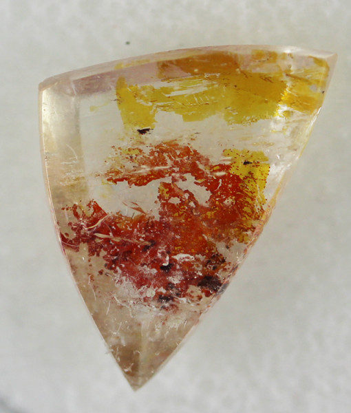 A triangular piece of yellow and orange quartz.