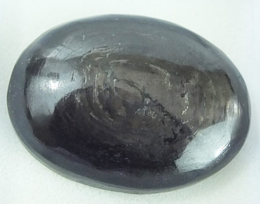 A black stone on a white surface.