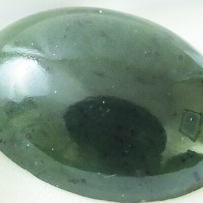 A green jade stone in a white box.