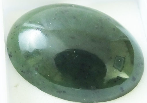 A green jade stone in a white box.
