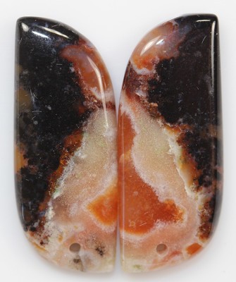 A pair of orange and black agate cabochons.