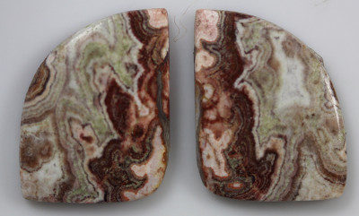 A pair of brown and green agate cabochons.