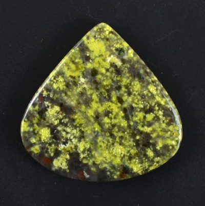 A yellow and green jasper pendant on a black background.