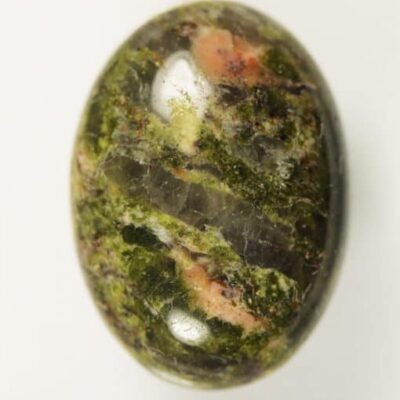 A Unakite 11.43cts Oval Cabochon 18.00 x 13.00mm Q0320 H6-7 discovery in South Carolina, USA Q0320 on a white surface.