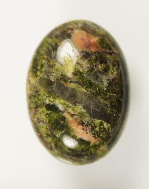 A Unakite 11.43cts Oval Cabochon 18.00 x 13.00mm Q0320 H6-7 discovery in South Carolina, USA Q0320 on a white surface.