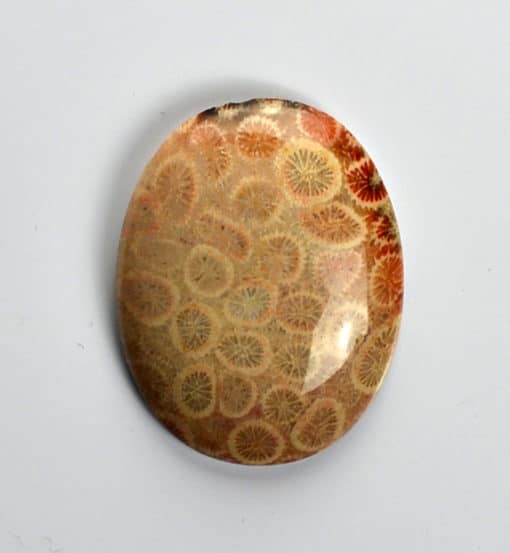 A round piece of stone with a pattern on it.