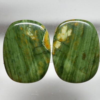 A pair of green jade stud earrings.