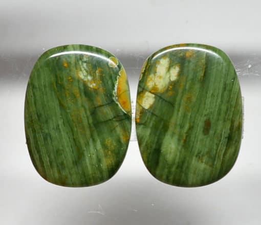 A pair of green jade stud earrings.