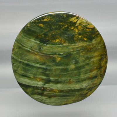 A piece of green jasper on a white background.