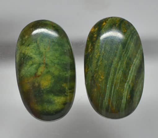 A pair of green jade cabochons.