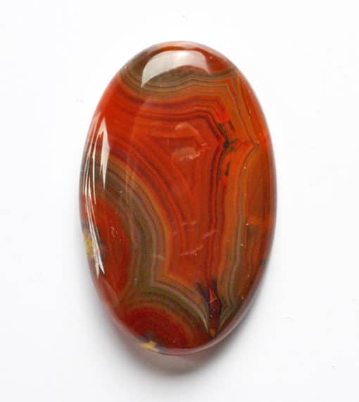 A red agate oval cabochon on a white background.