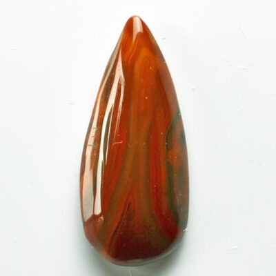 A piece of red agate on a white surface.