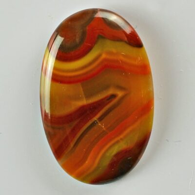 An orange and yellow agate oval cabochon.