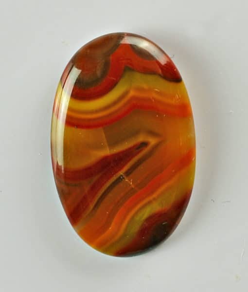 An orange and yellow agate oval cabochon.