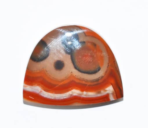 A piece of agate with an orange and black pattern.