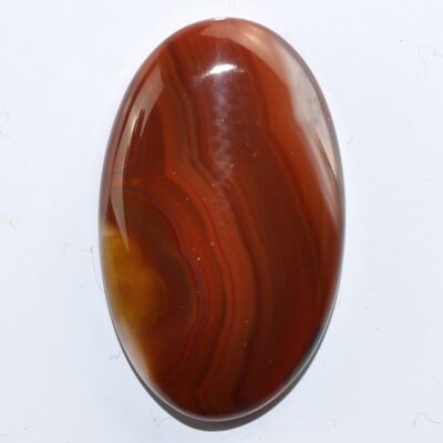 An oval agate stone on a white surface.
