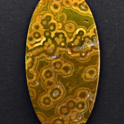 An oval shaped piece of yellow and green agate.