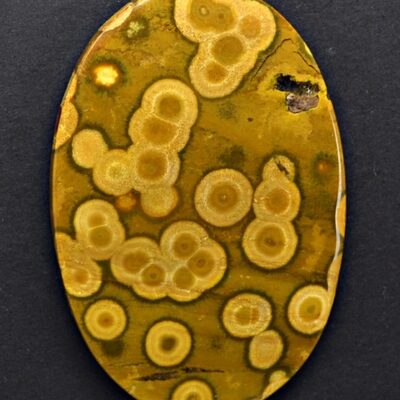 A yellow and brown oval shaped piece of jasper.