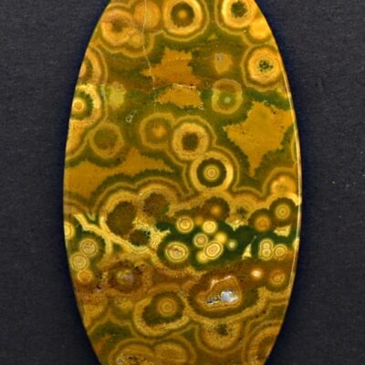 A yellow and brown agate oval cabochon.