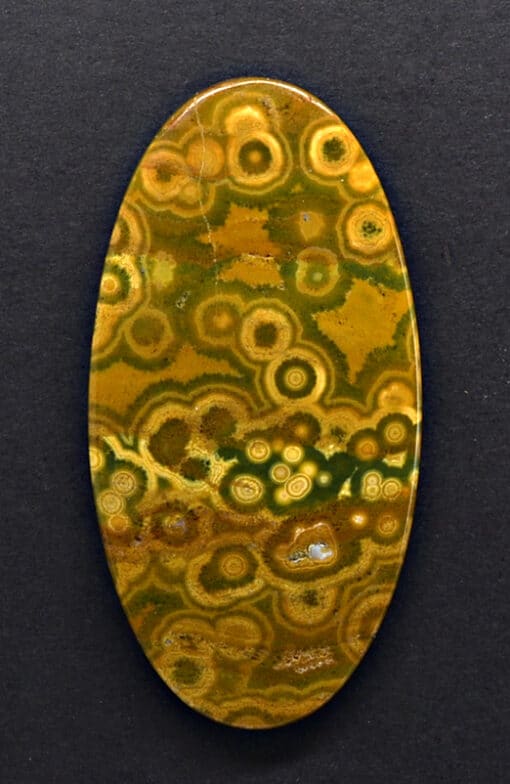 A yellow and brown agate oval cabochon.