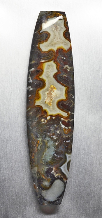 A piece of agate on a metal surface.