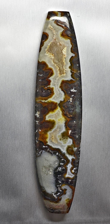 A piece of agate on a metal surface.