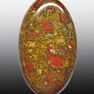 A red, yellow and green stone cabochon.
