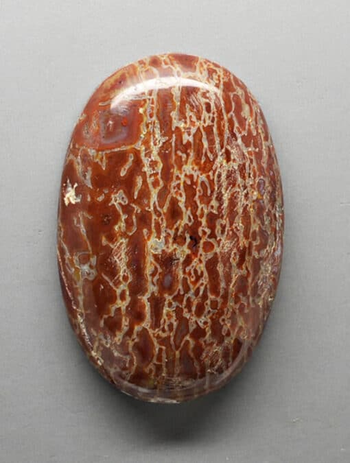 A piece of red jasper on a white surface.