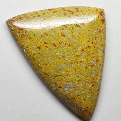 A yellow stone with a black and white pattern on it.