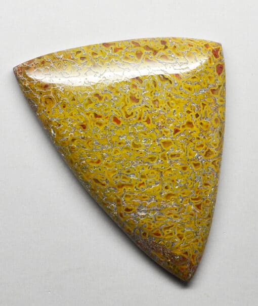 A yellow stone with a black and white pattern on it.