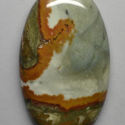 A green and orange agate cabochon on a white background.