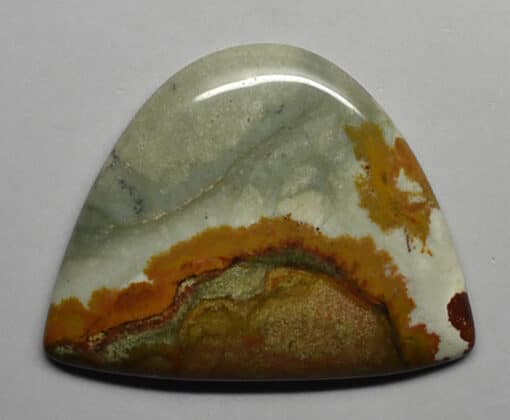 A piece of green and orange agate on a white surface.
