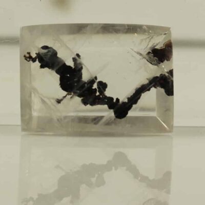 A piece of quartz with black streaks on it.