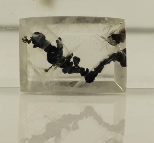 A piece of quartz with black streaks on it.