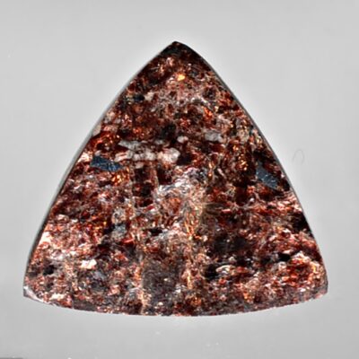 A triangular shaped piece of brown stone.