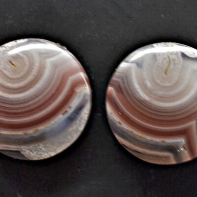 A pair of brown and white agate cabochons.