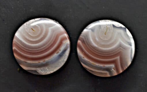 A pair of brown and white agate cabochons.
