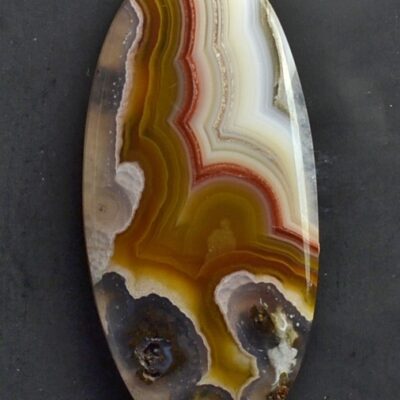 A piece of agate on a black surface.