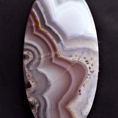 A piece of agate on a black surface.