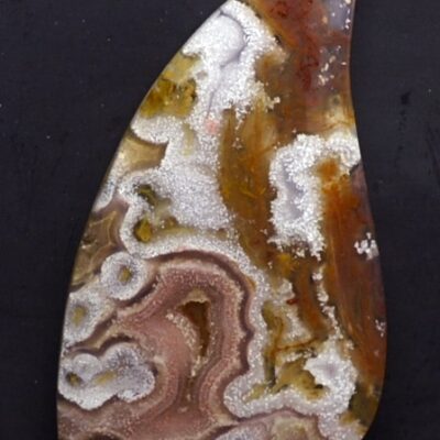 A piece of agate on a black surface.