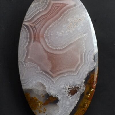 A round piece of agate on a black background.