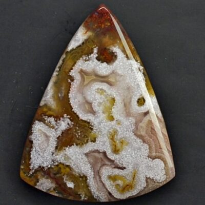 A triangular piece of agate with white and brown swirls.