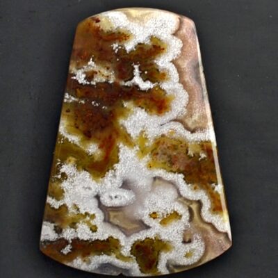 A piece of agate with white and brown swirls.