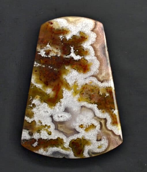 A piece of agate with white and brown swirls.