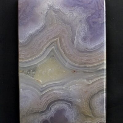 A piece of purple agate on a black surface.