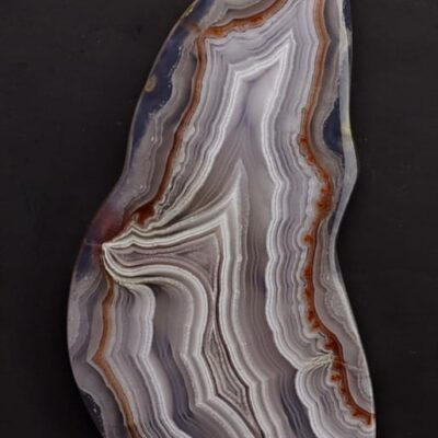 A piece of agate on a black surface.