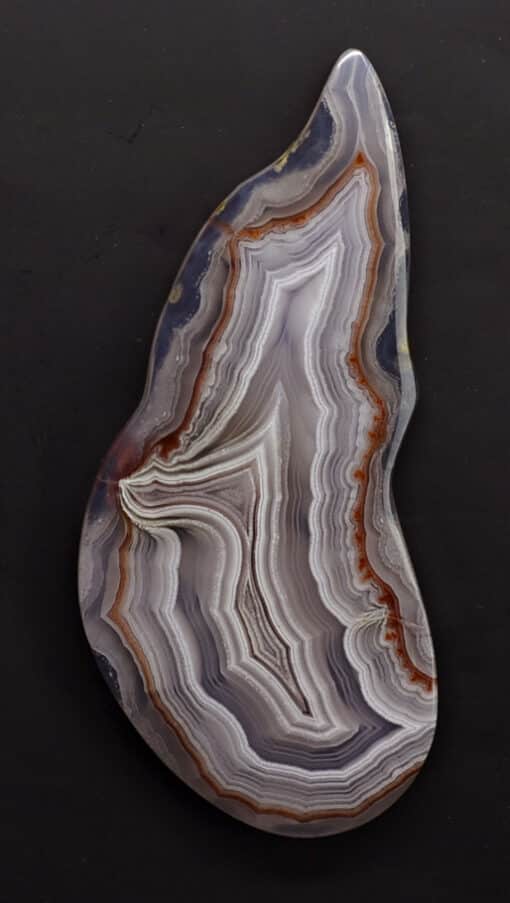 A piece of agate on a black surface.